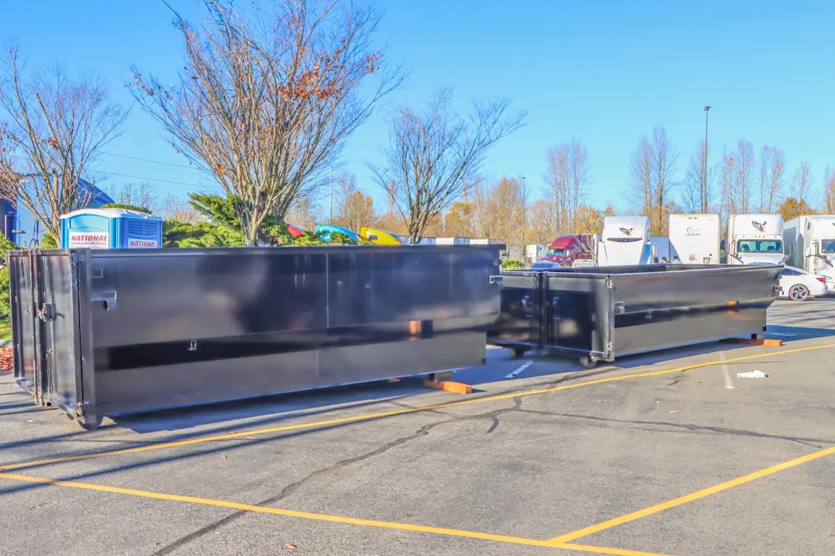 Professional dumpster rental service with roll-off container on residential driveway in Tiffin